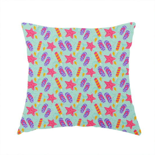 The fabric used to create this handmade cushion is a playful summer pattern featuring pink starfish, flip-flops, and striped popsicles set against a light turquoise background.