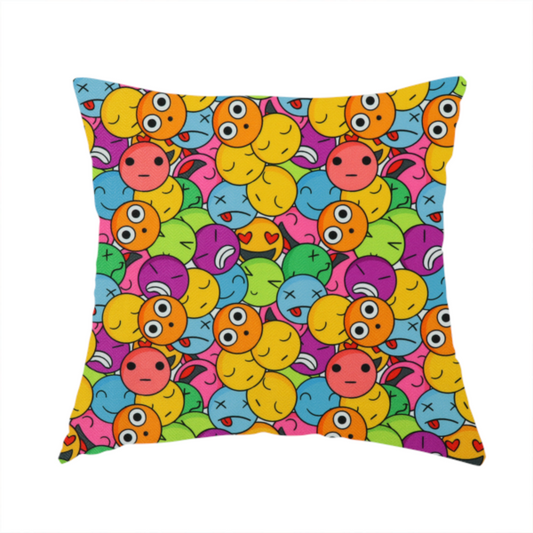 The fabric used to create this handmade cushion is a dense, overlapping pattern of colourful, stylized emoji faces displaying various cartoonish expressions, including winking, laughing, dizzy, and neutral expressions, in a vibrant mix of yellow, orange, blue, green, and pink.
