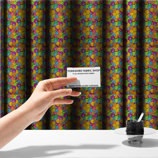 The fabric used to create these made-to-measure curtains is a dense, overlapping pattern of colourful, stylized emoji faces displaying various cartoonish expressions, including winking, laughing, dizzy, and neutral expressions, in a vibrant mix of yellow, orange, blue, green, and pink.