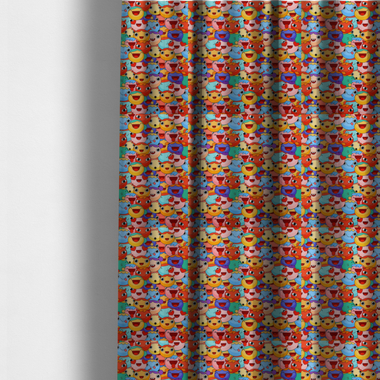 The fabric used to create these made-to-measure curtains is a dense, overlapping pattern of colourful, stylized cartoon faces featuring wide smiles, sticking-out tongues, and various cheerful or cheeky expressions in vibrant shades of pink, orange, yellow, blue, and purple.