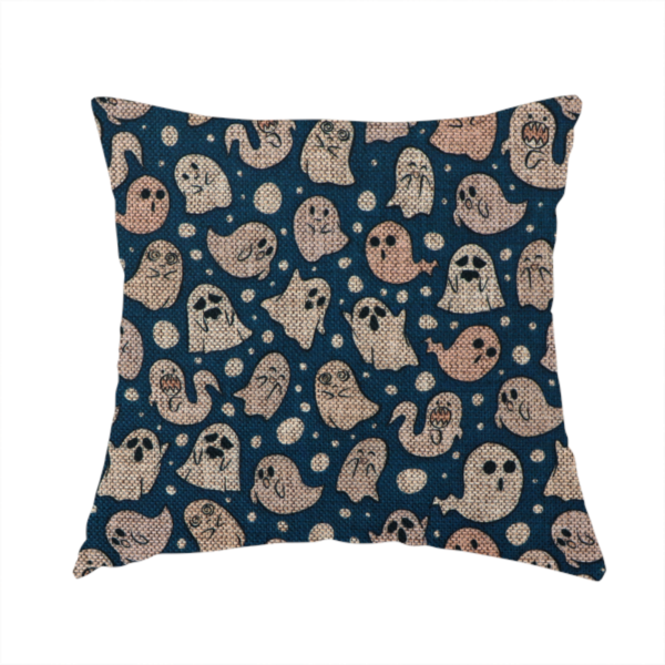 The fabric used to create this handmade cushion is a dark blue fabric patterned with an all-over, repeating design of light beige and peach cartoon ghosts with various cute and silly facial expressions, interspersed with small white polka dots.