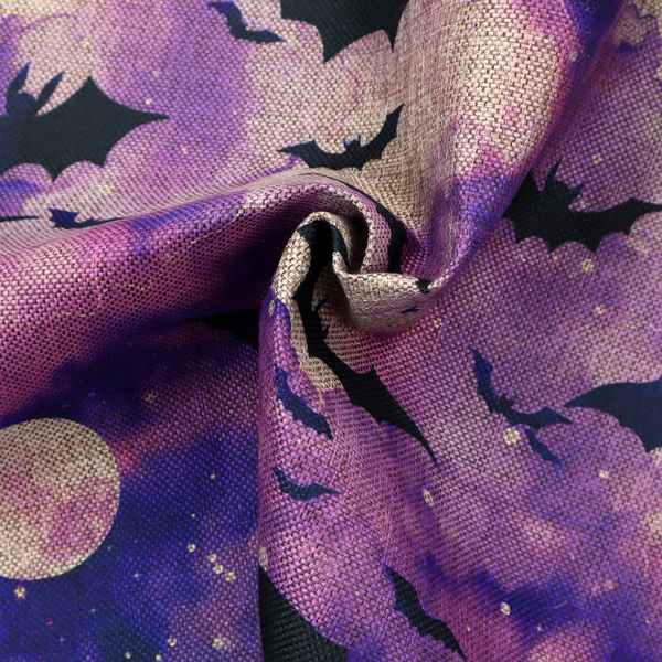 A watercolour-style Halloween fabric featuring a spooky night sky in shades of purple and pink, filled with silhouettes of flying black bats and two pale full moons.