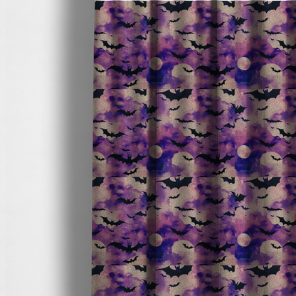 The fabric used to create these made-to-measure curtains is a watercolour-style Halloween fabric featuring a spooky night sky in shades of purple and pink, filled with silhouettes of flying black bats and two pale full moons.