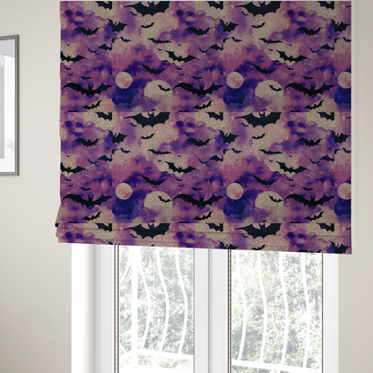 The fabric used to create these Roman blinds is a watercolour-style Halloween fabric featuring a spooky night sky in shades of purple and pink, filled with silhouettes of flying black bats and two pale full moons.