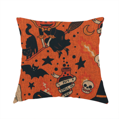 The fabric used to create this handmade cushion is an orange Halloween fabric patterned with various black illustrations, including a witch with a pumpkin head flying on a broomstick, a black cat, ghosts, skulls, potion bottles with the text "I put a spell on you," bats, cauldrons, and stars.