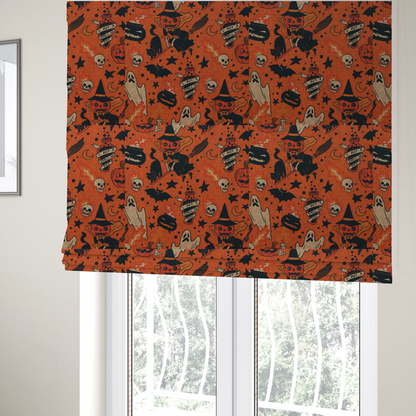 The fabric used to create these Roman blinds is an orange Halloween fabric patterned with various black illustrations, including a witch with a pumpkin head flying on a broomstick, a black cat, ghosts, skulls, potion bottles with the text "I put a spell on you," bats, cauldrons, and stars.