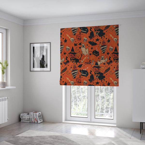 The fabric used to create these Roman blinds is an orange Halloween fabric patterned with various black illustrations, including a witch with a pumpkin head flying on a broomstick, a black cat, ghosts, skulls, potion bottles with the text "I put a spell on you," bats, cauldrons, and stars.