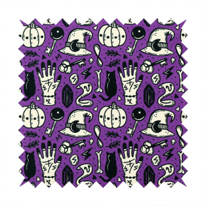 A purple Halloween fabric patterned with repeating black and cream illustrations of pumpkins, witch hats, black cats, mystical marked hands, snakes, keys, bones, and crystals.