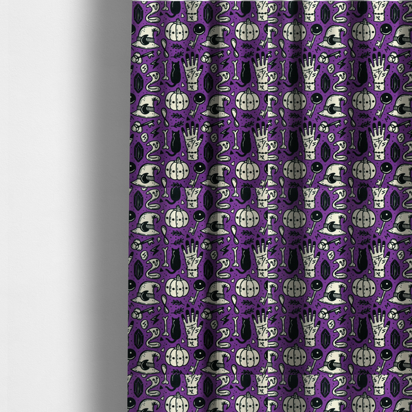 The fabric used to create these made-to-measure curtains is a purple Halloween fabric patterned with repeating black and cream illustrations of pumpkins, witch hats, black cats, mystical marked hands, snakes, keys, bones, and crystals.