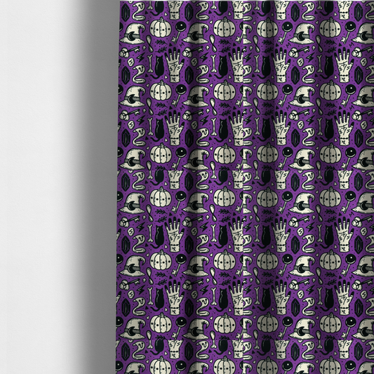 The fabric used to create these made-to-measure curtains is a purple Halloween fabric patterned with repeating black and cream illustrations of pumpkins, witch hats, black cats, mystical marked hands, snakes, keys, bones, and crystals.