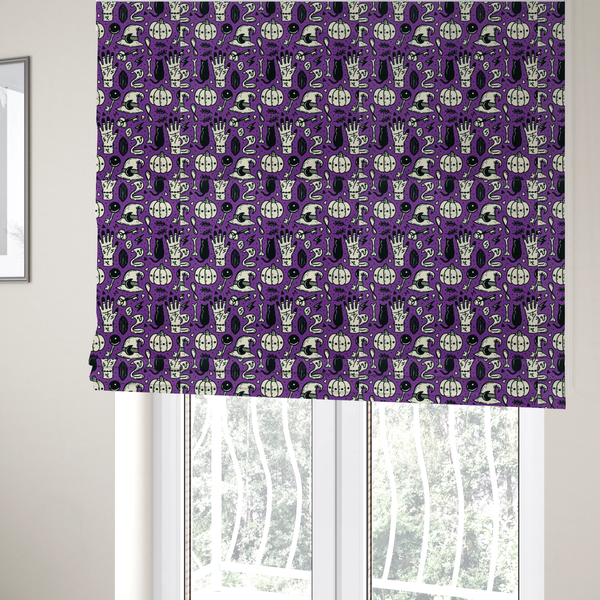 The fabric used to create these Roman blinds is a purple Halloween fabric patterned with repeating black and cream illustrations of pumpkins, witch hats, black cats, mystical marked hands, snakes, keys, bones, and crystals.