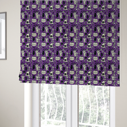 The fabric used to create these Roman blinds is a purple Halloween fabric patterned with repeating black and cream illustrations of pumpkins, witch hats, black cats, mystical marked hands, snakes, keys, bones, and crystals.