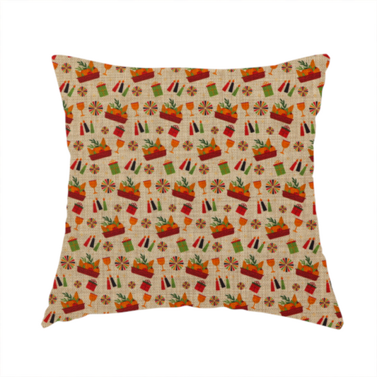 The fabric used to create this handmade cushion is a repeating pattern of festive celebration icons including baskets filled with greenery, candles, wrapped gifts, goblets, and decorative pinwheels on a textured tan background.