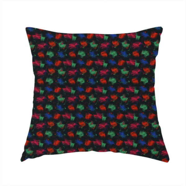 The fabric used to create this handmade cushion is a textured tweed-style fabric featuring a dark background interwoven with dense specks of vibrant red, green, and blue flecks.