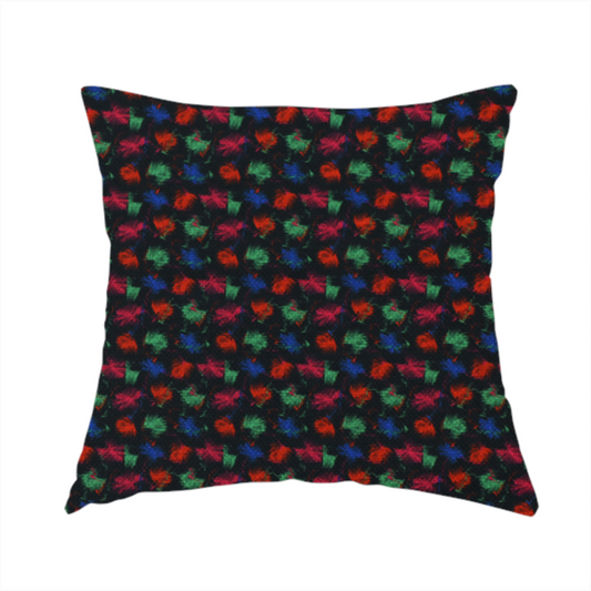 The fabric used to create this handmade cushion is a textured tweed-style fabric featuring a dark background interwoven with dense specks of vibrant red, green, and blue flecks.
