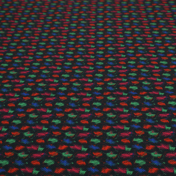 A textured tweed-style fabric featuring a dark background interwoven with dense specks of vibrant red, green, and blue flecks.