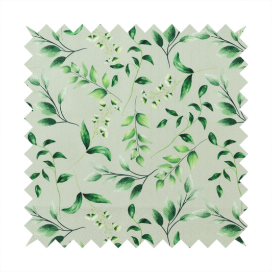 Watercolour botanical fabric featuring a repeating pattern of leafy green branches and delicate white blossoms on a light sage-grey twill background.