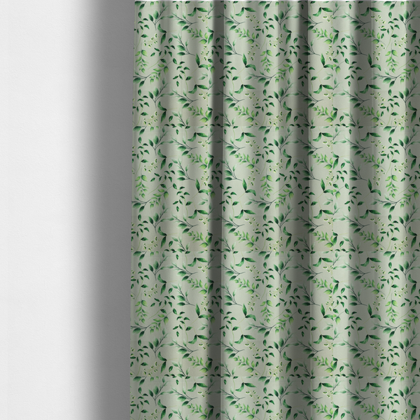 The fabric used to create these made-to-measure curtains is a watercolour botanical fabric featuring a repeating pattern of leafy green branches and delicate white blossoms on a light sage-grey twill background.