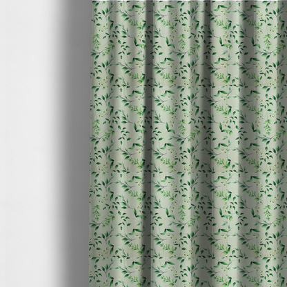 The fabric used to create these made-to-measure curtains is a watercolour botanical fabric featuring a repeating pattern of leafy green branches and delicate white blossoms on a light sage-grey twill background.