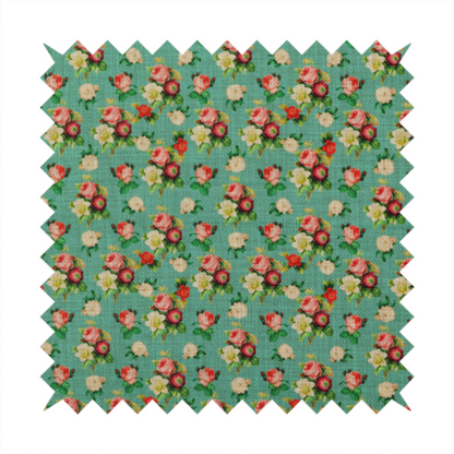 A charming repeating pattern of small bouquets featuring pink and red roses paired with white blossoms and green leaves set against a textured teal background.