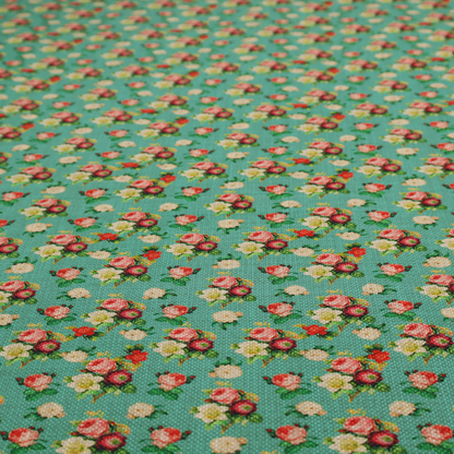 A charming repeating pattern of small bouquets featuring pink and red roses paired with white blossoms and green leaves set against a textured teal background.