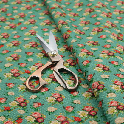 A charming repeating pattern of small bouquets featuring pink and red roses paired with white blossoms and green leaves set against a textured teal background.
