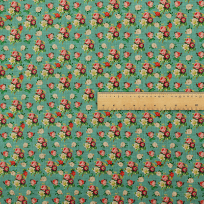 A charming repeating pattern of small bouquets featuring pink and red roses paired with white blossoms and green leaves set against a textured teal background.