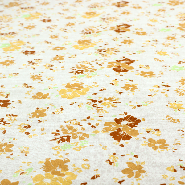 A delicate, ditsy floral repeating pattern on an off-white background featuring small clusters of flowers and leaves in shades of yellow, gold, brown, and pale green.