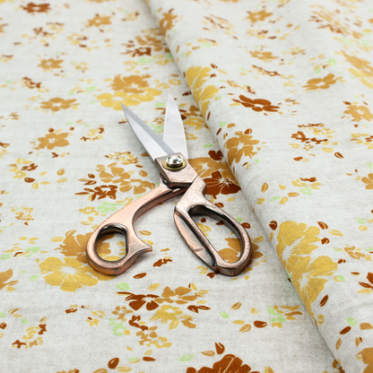 A delicate, ditsy floral repeating pattern on an off-white background featuring small clusters of flowers and leaves in shades of yellow, gold, brown, and pale green.