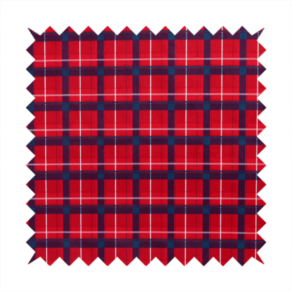 A vibrant red plaid and tartan pattern featuring intersecting dark blue and white stripes over a bold red background.