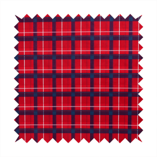 A vibrant red plaid and tartan pattern featuring intersecting dark blue and white stripes over a bold red background.