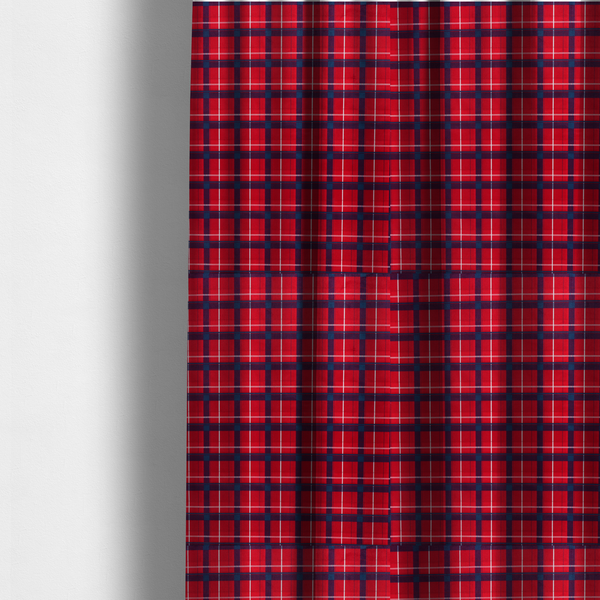 The fabric used to create these made-to-measure curtains is a vibrant red plaid and tartan pattern featuring intersecting dark blue and white stripes over a bold red background.