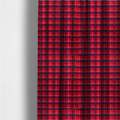 The fabric used to create these made-to-measure curtains is a vibrant red plaid and tartan pattern featuring intersecting dark blue and white stripes over a bold red background.