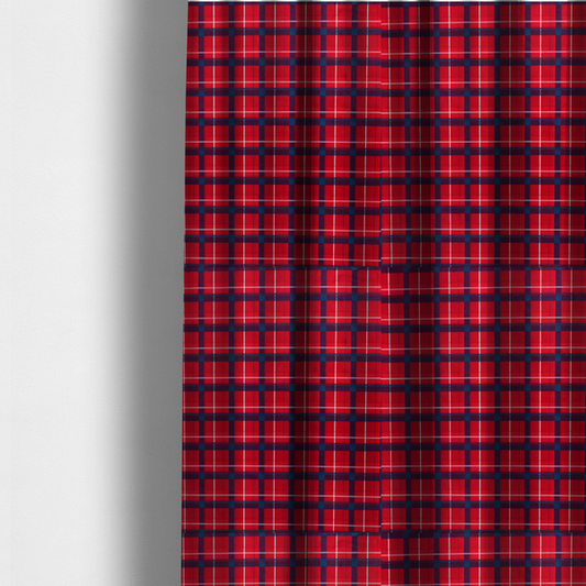 The fabric used to create these made-to-measure curtains is a vibrant red plaid and tartan pattern featuring intersecting dark blue and white stripes over a bold red background.