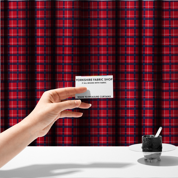 The fabric used to create these made-to-measure curtains is a vibrant red plaid and tartan pattern featuring intersecting dark blue and white stripes over a bold red background.