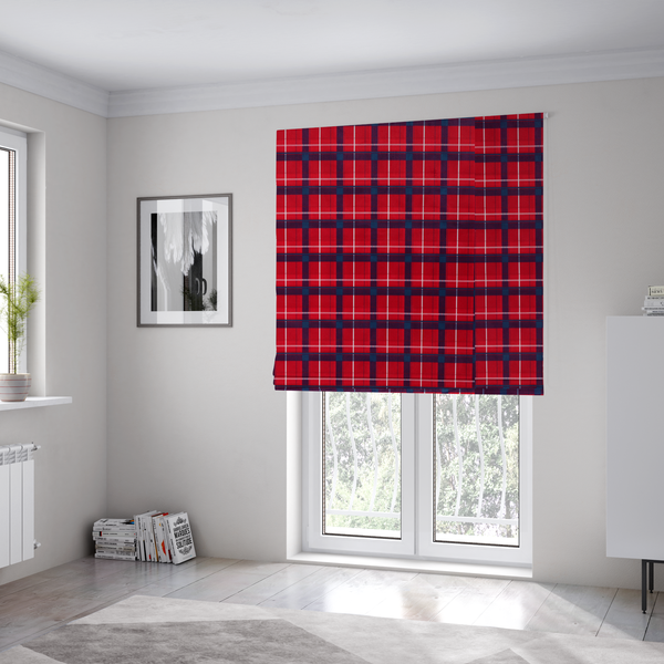 The fabric used to create these Roman blinds is a vibrant red plaid and tartan pattern featuring intersecting dark blue and white stripes over a bold red background.