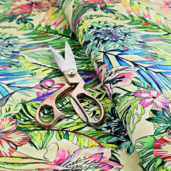 A vibrant, dense tropical pattern featuring colourful hibiscus and orchid flowers, spiky blue and white blooms, and lush green and blue palm leaves.