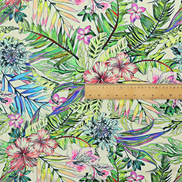 A vibrant, dense tropical pattern featuring colourful hibiscus and orchid flowers, spiky blue and white blooms, and lush green and blue palm leaves.