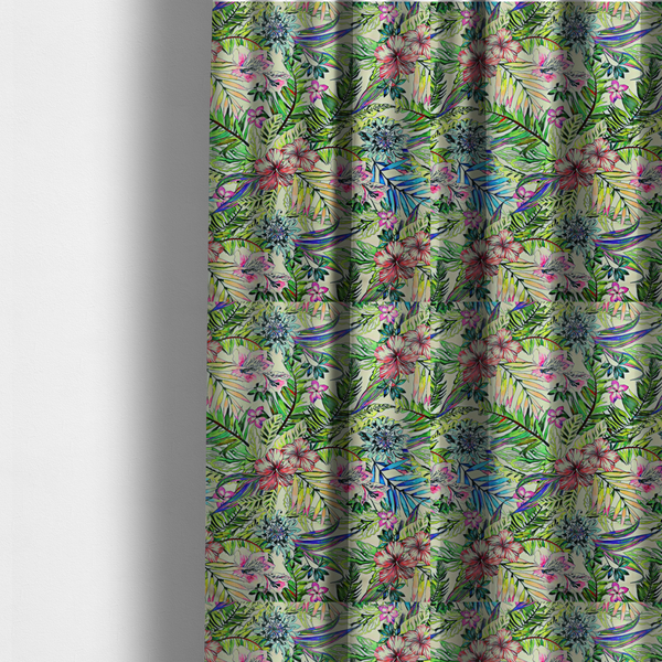 The fabric used to create these made-to-measure curtains is a vibrant, dense tropical pattern featuring colourful hibiscus and orchid flowers, spiky blue and white blooms, and lush green and blue palm leaves.
