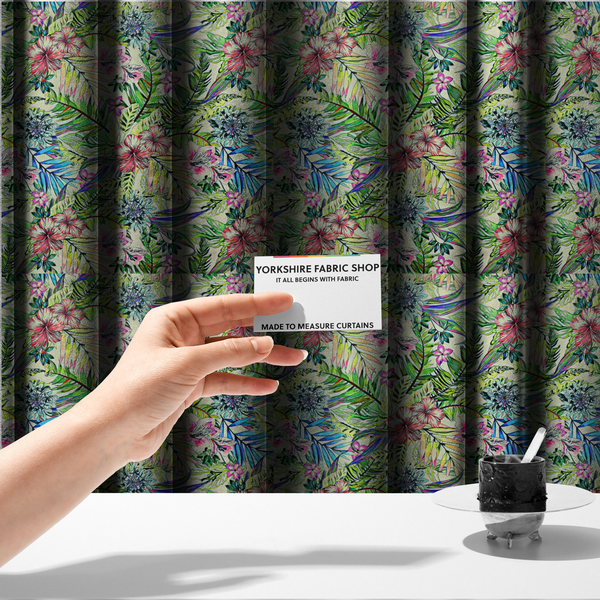 The fabric used to create these made-to-measure curtains is a vibrant, dense tropical pattern featuring colourful hibiscus and orchid flowers, spiky blue and white blooms, and lush green and blue palm leaves.
