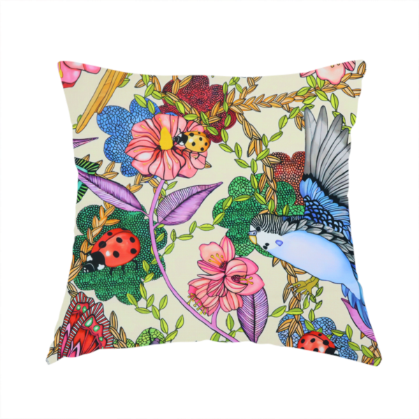 The fabric used to create this handmade cushion is a colourful and detailed repeating pattern on a light background featuring blue and yellow birds, bright butterflies, ladybugs, and vibrant pink flowers.