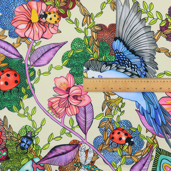 A colourful and detailed repeating pattern on a light background featuring blue and yellow birds, bright butterflies, ladybugs, and vibrant pink flowers.