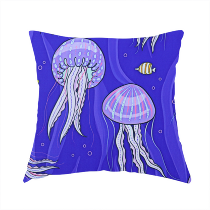 The fabric used to create this handmade cushion is a vibrant underwater pattern on a rich blue background featuring glowing purple and pink jellyfish, tiny colourful fish, and floating bubbles.