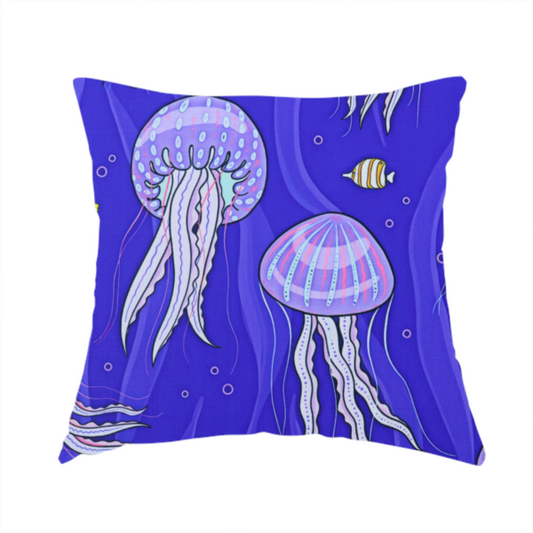 The fabric used to create this handmade cushion is a vibrant underwater pattern on a rich blue background featuring glowing purple and pink jellyfish, tiny colourful fish, and floating bubbles.