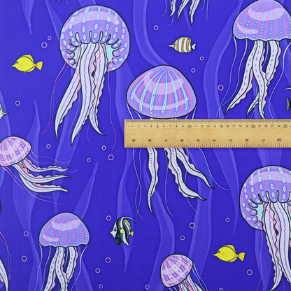 A vibrant underwater pattern on a rich blue background featuring glowing purple and pink jellyfish, tiny colourful fish, and floating bubbles.