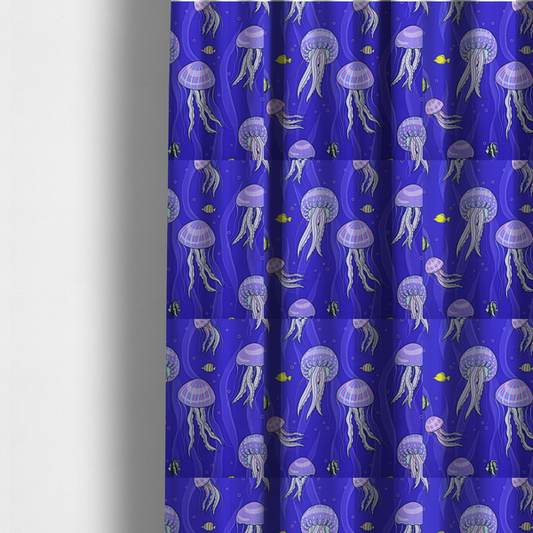 The fabric used to create these made-to-measure curtains is a vibrant underwater pattern on a rich blue background featuring glowing purple and pink jellyfish, tiny colourful fish, and floating bubbles.