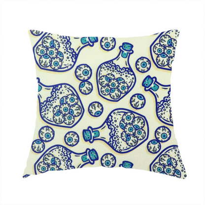 The fabric used to create this handmade cushion is a repeating blue-and-white line-art pattern on a light beige background featuring glass potion bottles filled with piles of detailed eyeballs, surrounded by scattered loose eyeballs.
