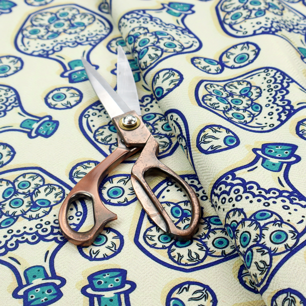 A repeating blue-and-white line-art pattern on a light beige background featuring glass potion bottles filled with piles of detailed eyeballs, surrounded by scattered loose eyeballs.