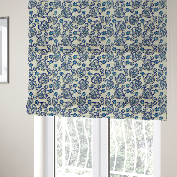 The fabric used to create these Roman blinds is a repeating blue-and-white line-art pattern on a light beige background featuring glass potion bottles filled with piles of detailed eyeballs, surrounded by scattered loose eyeballs.
