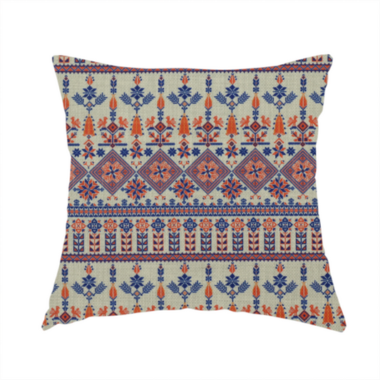 The fabric used to create this handmade cushion is an intricate folk-inspired fabric featuring horizontal bands of geometric diamonds, stylized birds, and floral motifs in navy blue and rust orange on a beige background.